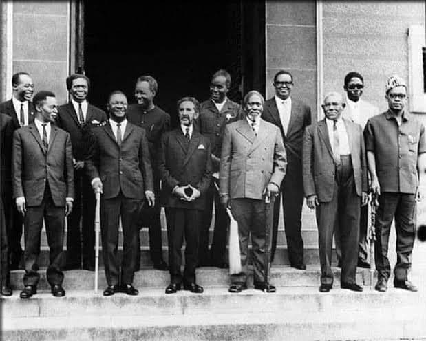 A black-and-white photograph of African heads of state standing in two rows on the steps of a building for a group portrait.