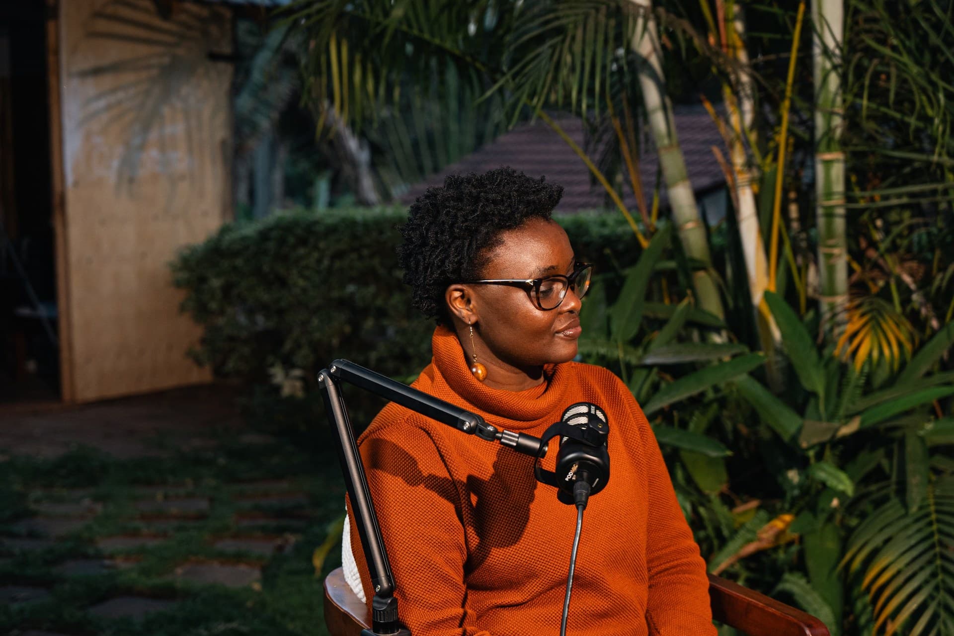 The episode's co-host, seated in profile at a microphone.