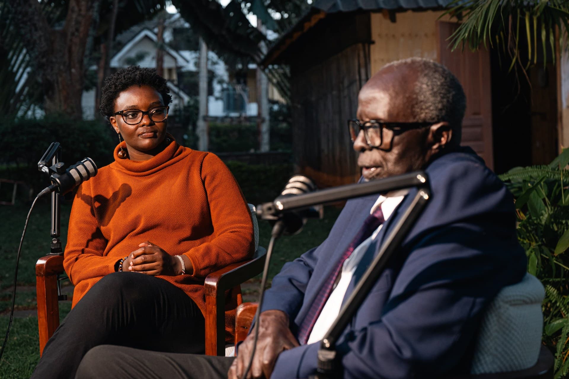 Dr. Aldo Ajou Deng-Akuey speaking, his co-host listening from the chair opposite.
