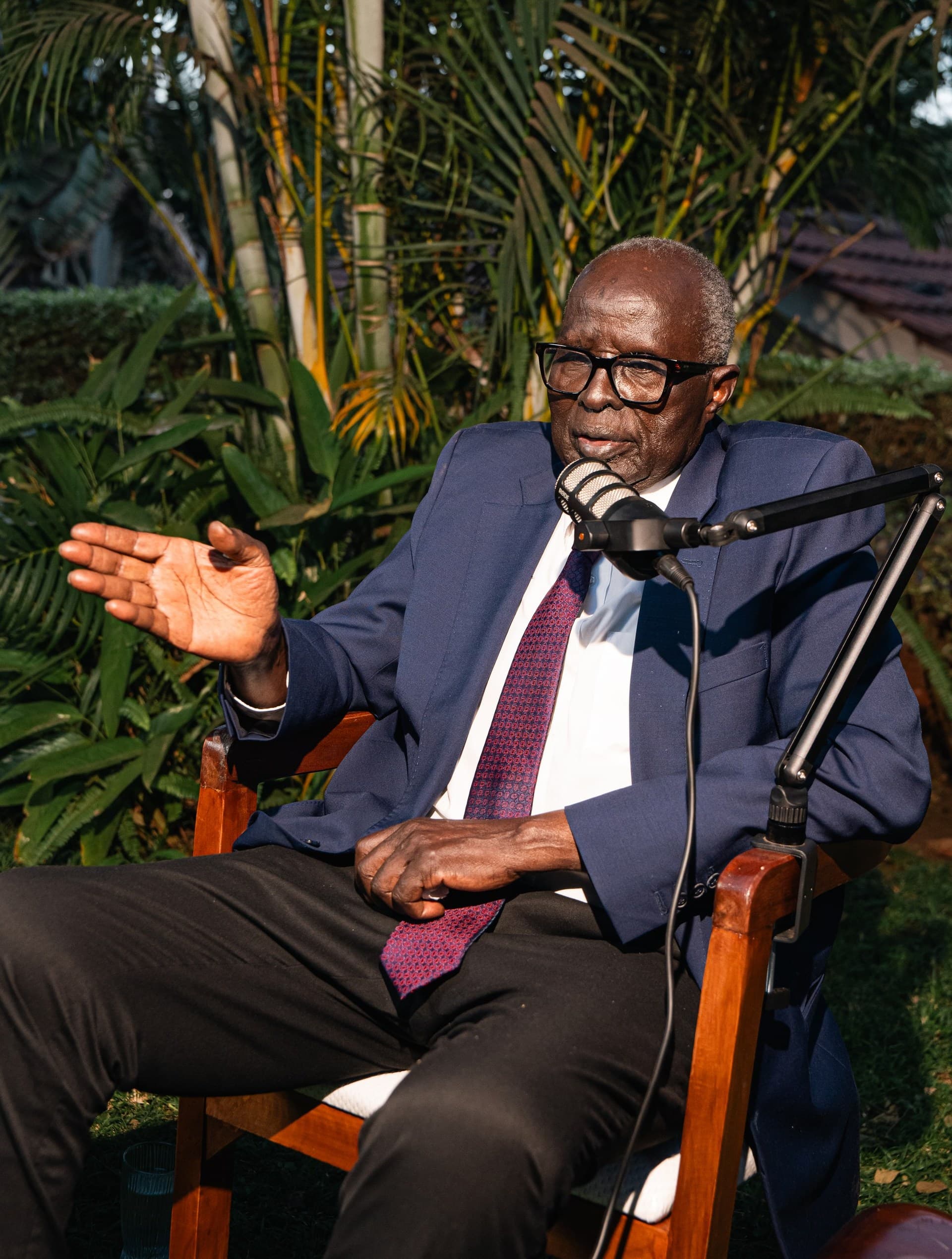 Dr. Aldo Ajou Deng-Akuey gesturing with an open hand as he makes a point.